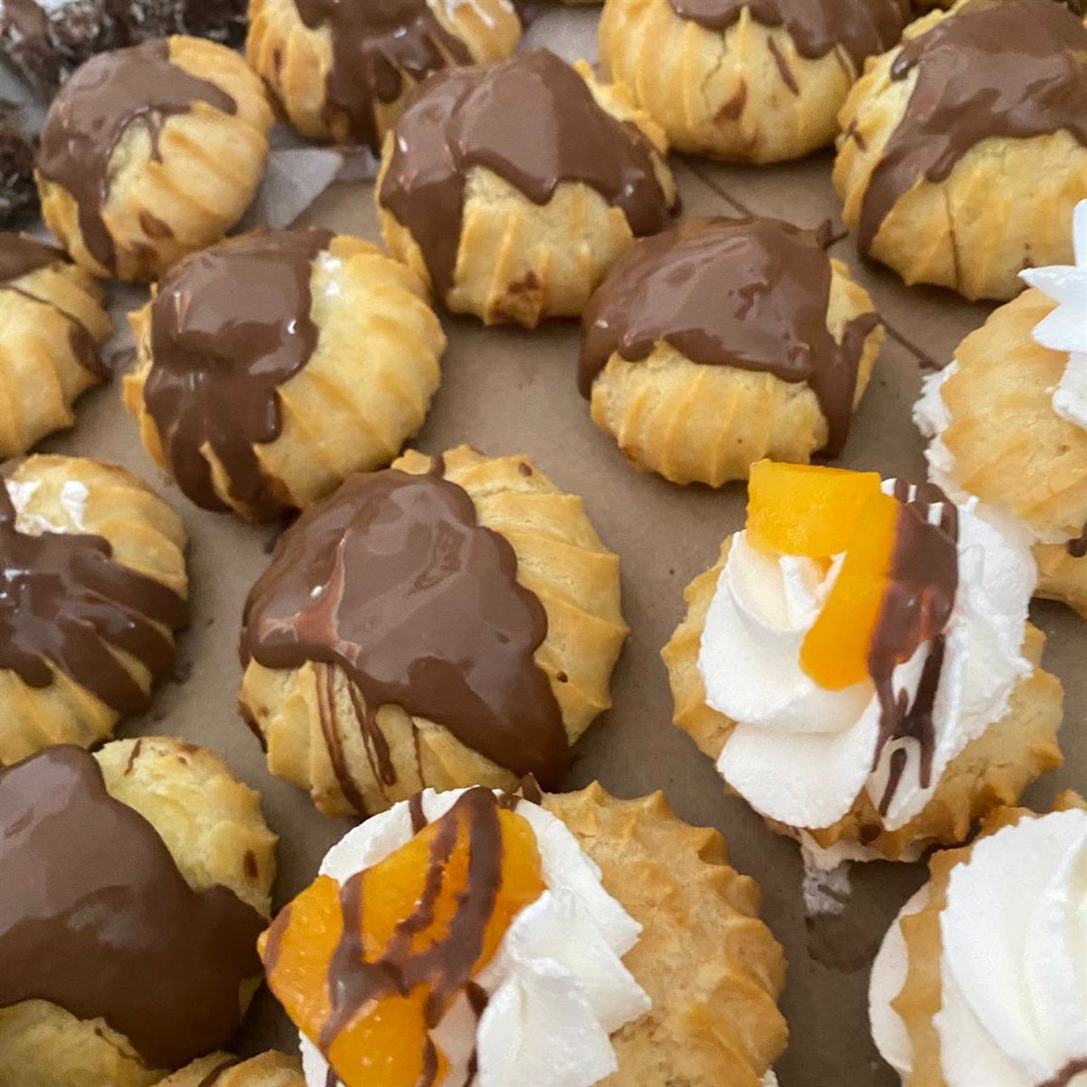 Assorted fancies with chocolate and cream toppings